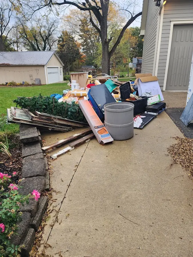 Dumpster being loaded with debris for Estate Cleanout Dumpster Rental in George Mason
